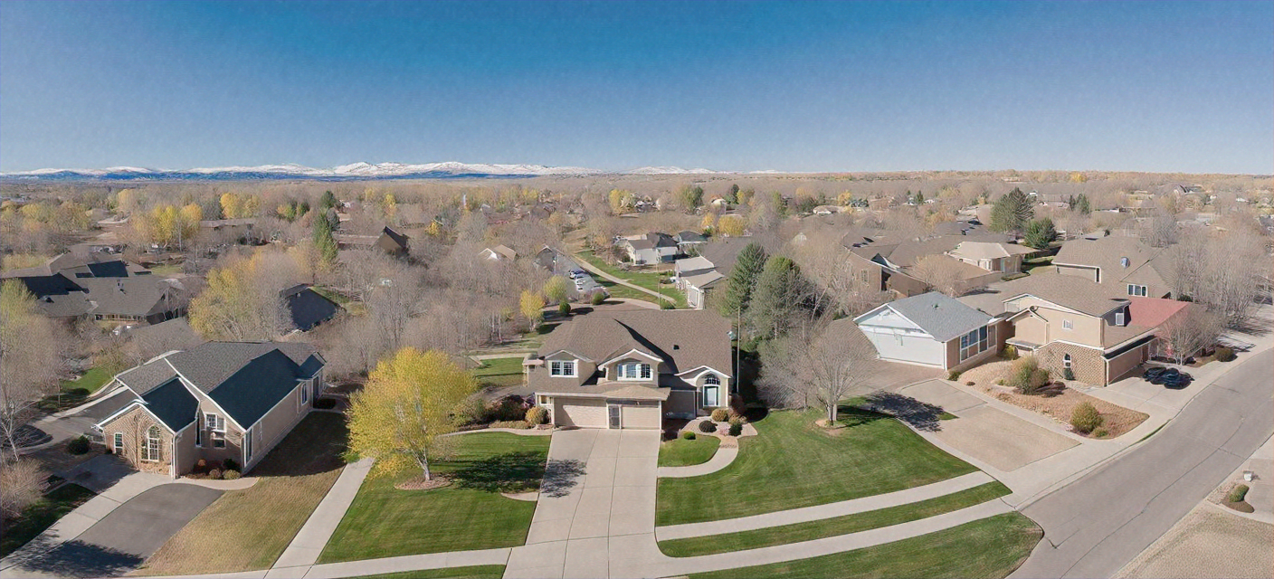 Upscale residential neighborhood street lined with beautiful homes for sale in Boulder Colorado